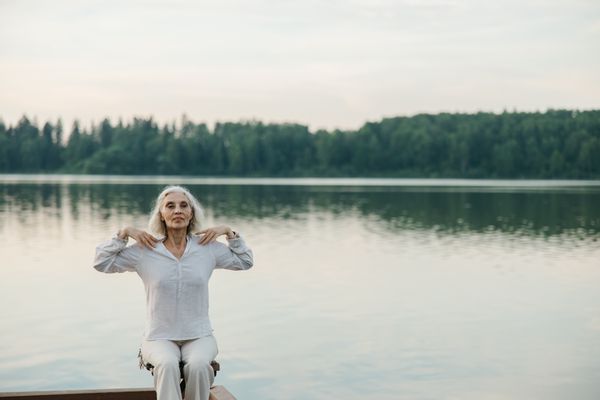 An older woman stretching outdoors