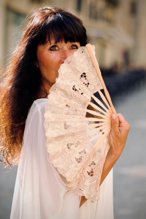 A woman fanning herself in the heat
