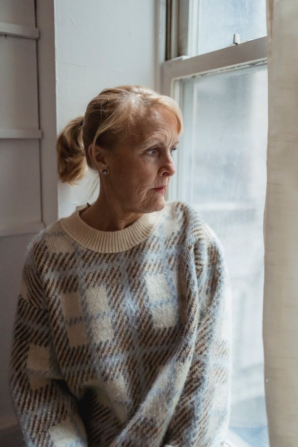 A woman gazing pensively out of a window