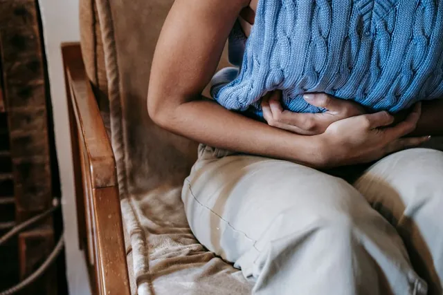 Hands pressed against a sore stomach