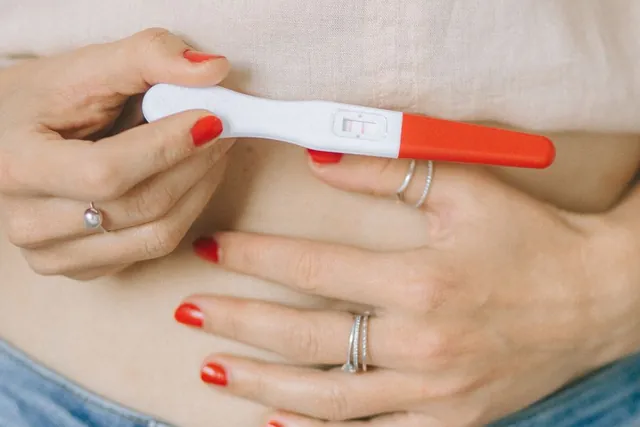 Hands holding a pregnancy test